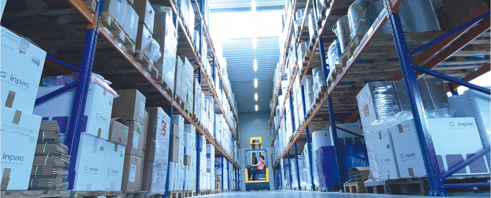 View of a full warehouse with multiple levels of shipping boxes. 
