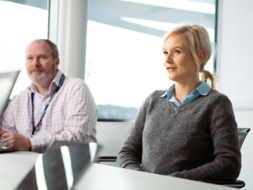 A man and a woman attending a meeting