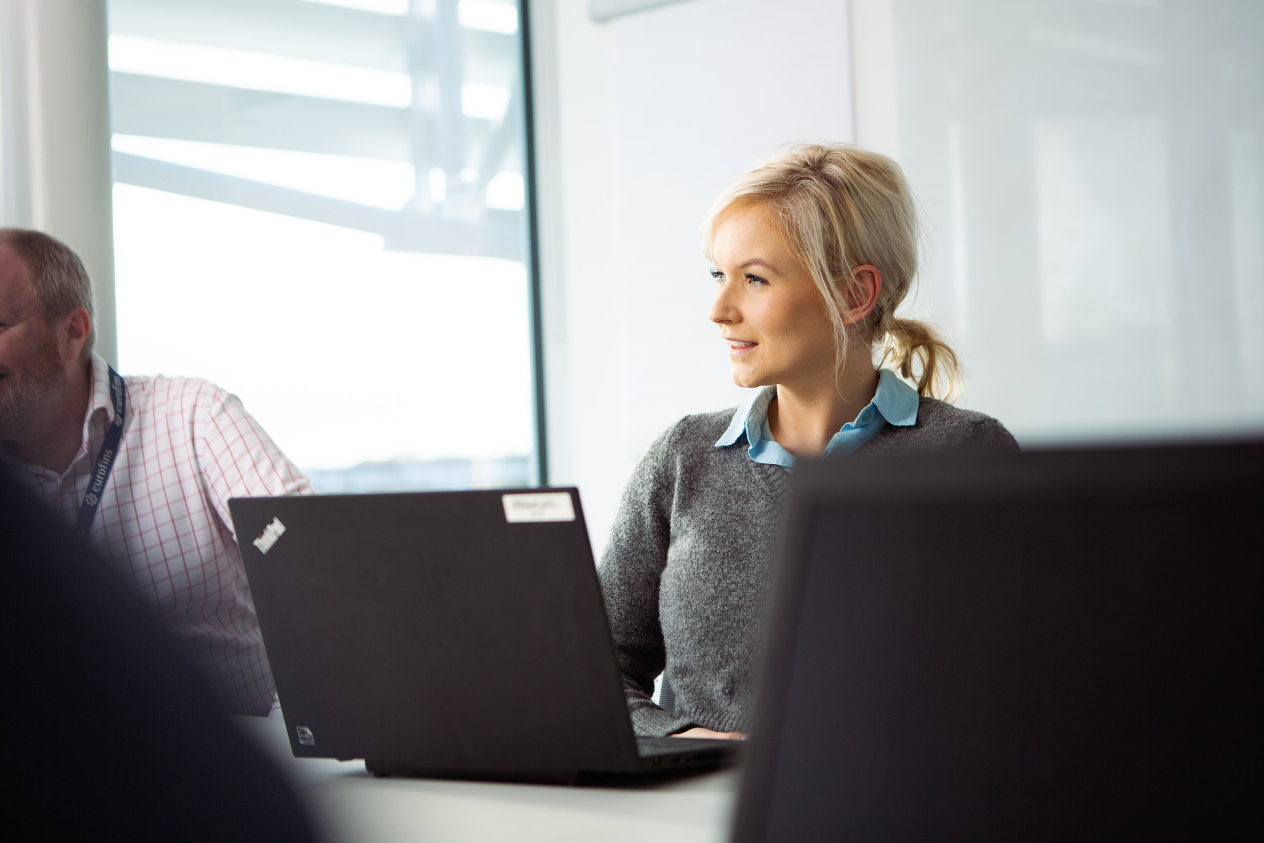 A group of people discussing in a conference room