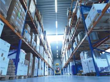 View of a full warehouse with multiple levels of shipping boxes. 